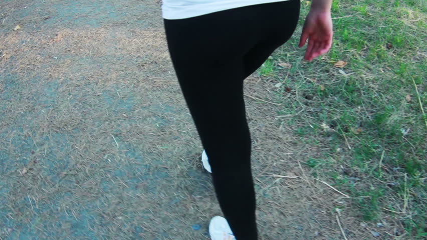 woman running in park, closeup shot of legs