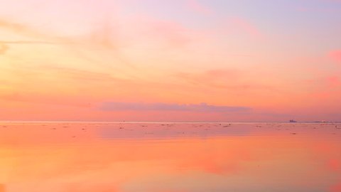 Beautiful sky and sea at dusk background. Sunset over ocean horizon, reflections in the calm water