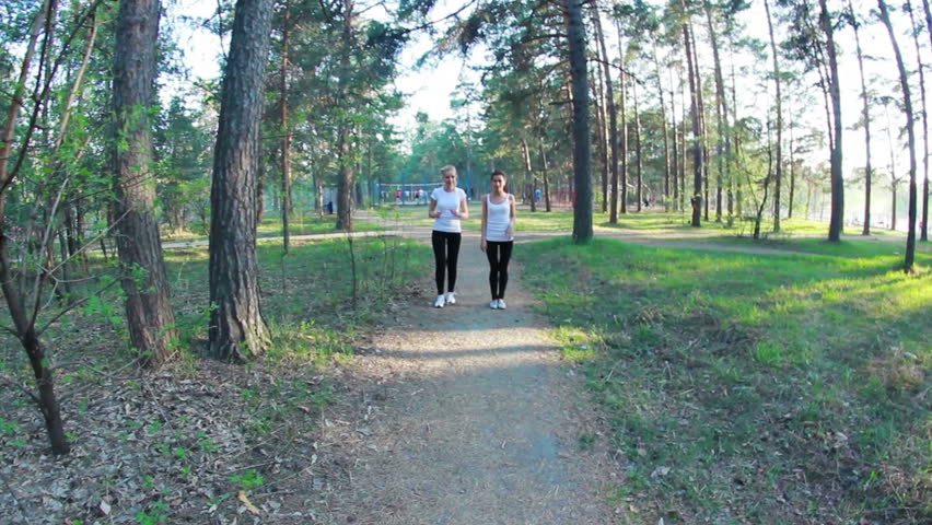 young women running in park, evening