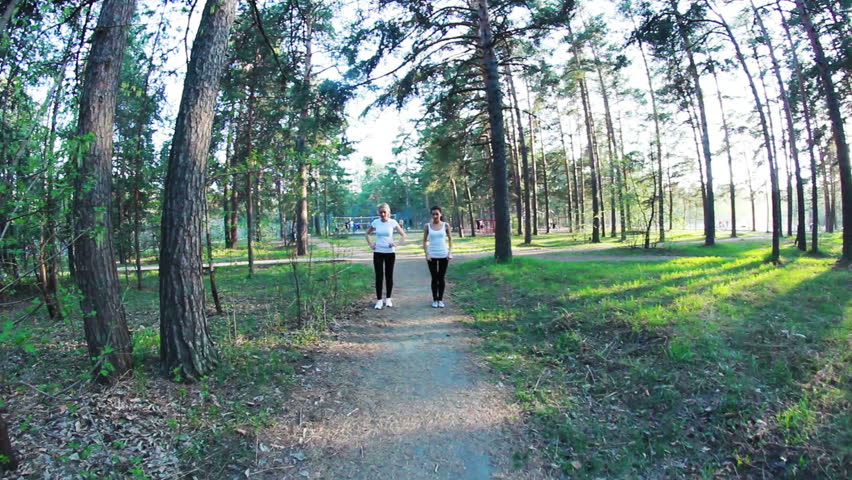 young women running in park, evening