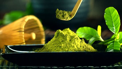 Organic Green Matcha Tea powder. Traditional Bamboo spoon with Matcha closeup. UHD video footage. Ultra high definition 3840X2160