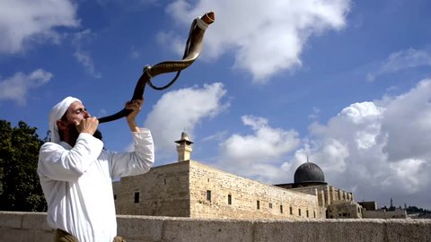 JERUSALEM ISRAEL - OCTOBER 12, 2015: Jewish man blowing the traditional Shofar ram horn for the Days of Awe, between the Feast of Trumpets and the Yom Kippur in front of Al-Aqsa mosque on Temple Mount