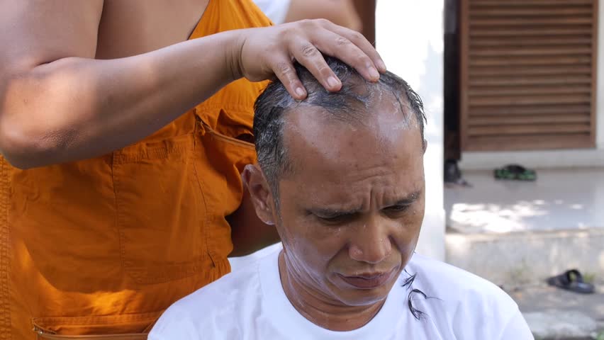 BANGKOK, THAILAND - NOVEMBER 15 : Thai people ordain Buddhist .monks hair shave young men to be ordained a new monk.on BANGKOK, THAILAND - NOVEMBER 15 2016 | Shutterstock HD Video #24013780