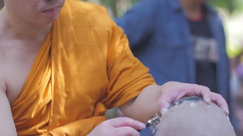 BANGKOK, THAILAND - NOVEMBER 15 : Thai people ordain Buddhist .monks hair shave young men to be ordained a new monk.on BANGKOK, THAILAND - NOVEMBER 15 2016 .Slow motion,high speed camera | Shutterstock HD Video #24013810