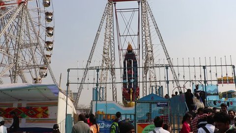 Surajkund, India - February 13, 2017: Visitors are enjoying at big swings/giant wheel in Surajkund craft fair.