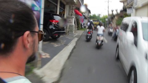 9.02.2017 Indonesia, Bali. Man riding a motorbike on the road