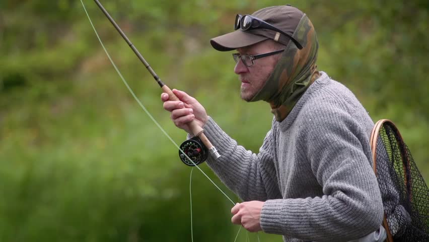 A fly fisherman casting, close up