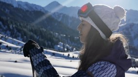 Footage of portrait snowboarder woman adventure, walking to snowy alps mountains, Swiss. Snowboard and ski healthy activities, hiking. Unique girl