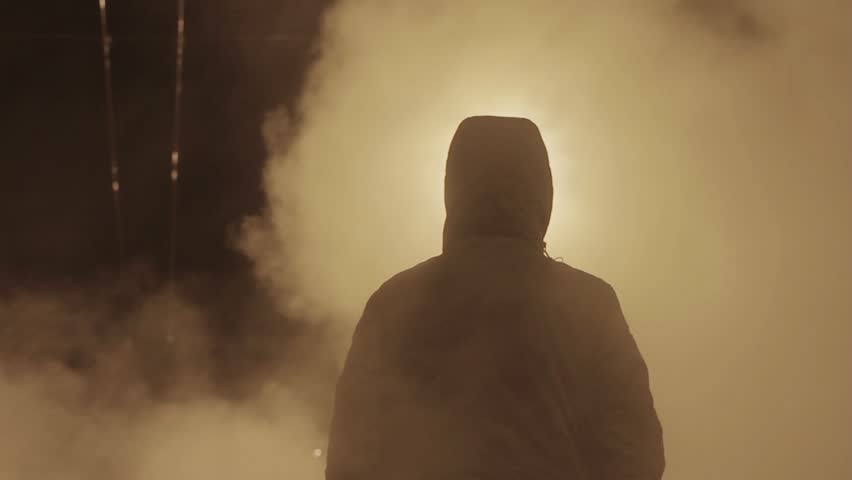 Silhouette of young man enveloped by steam on the night city road | Shutterstock HD Video #24032755