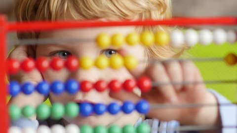 Caucasian Boy Learning Counting.
Young caucasian boy early learning counting on abacus.