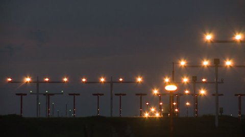Commercial Airliner landing on airport at night. 