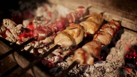 Process of cooking the shish kebab on coals on the grill