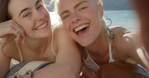 Girl friends taking selfie photograph with smartphone smiling two young woman enjoying  beautiful vacation travel adventure pov
