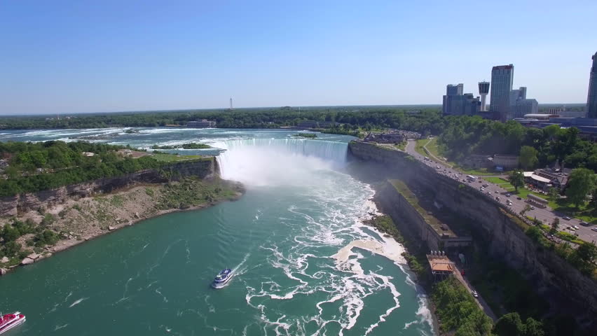 Niagara Falls aerial view, tourist boat in front of Horseshoe Falls on the border of US and Canada.