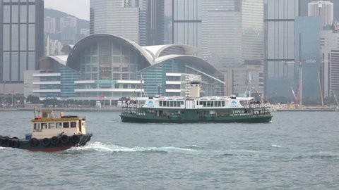 HONG KONG - DEC 23 2016 : Star Ferry is sailing through Victoria Harbour, with the skyline of Hong Kong as backdrop. 4K Video