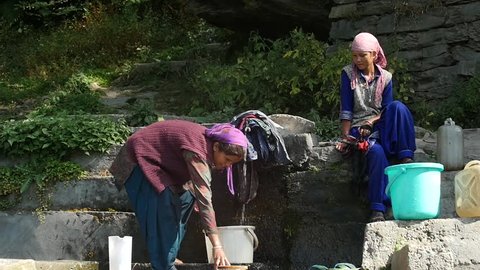 MANALI, INDIA - 24 SEPT 2016: Indian women wash clothes
