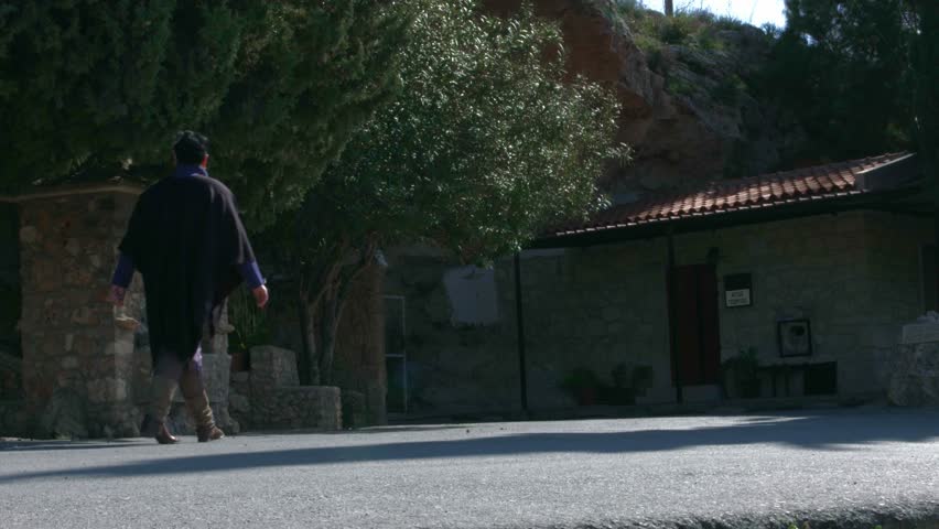 Slide shot of woman walks into the small church in Cyprus ( Paphos )