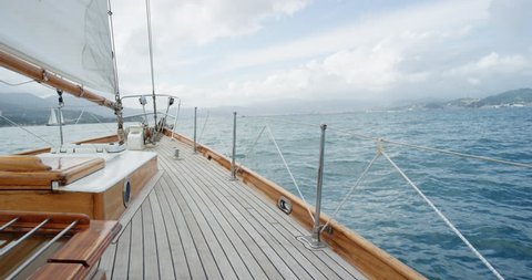 Wooden luxury sailboat sailing over ocean in beautiful blue mediterranean sea