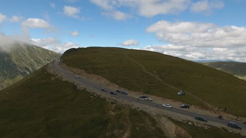 Aerial Nature scenic View. Car road on the top of a mountain, close to clouds and sky