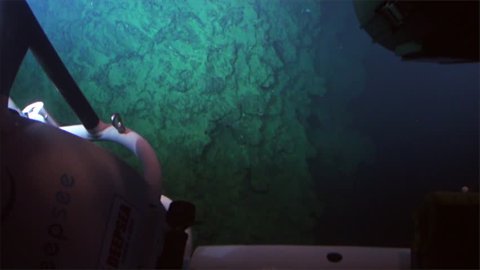 Cocos Island, Costa Rica - 21 September 2015: Cave, reefs, coral, deep sea view from submarine in 300 m depth - Pacific Ocean. Extreme diving. Swim in world of unique wildlife.
