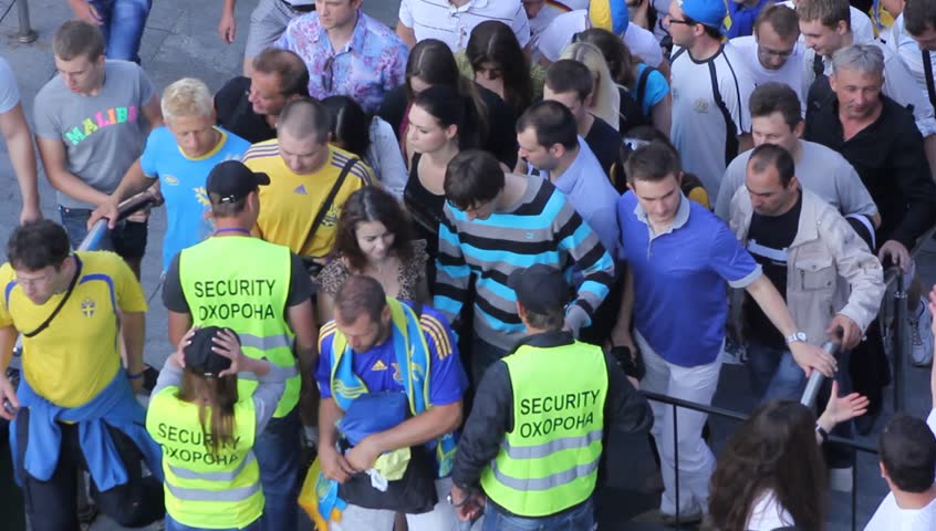 KIEVE - CIRCA 2012: Security checks incoming people at the Euro 2012 Fan zone