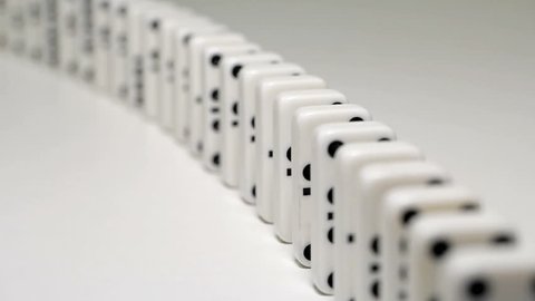 built figure of dominoes falling in slow motion