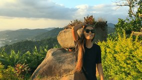 Young Beautiful Girl Walking to Amazing Viewpoint To See Sunset. Slow motion travel motivation video. Thailand.