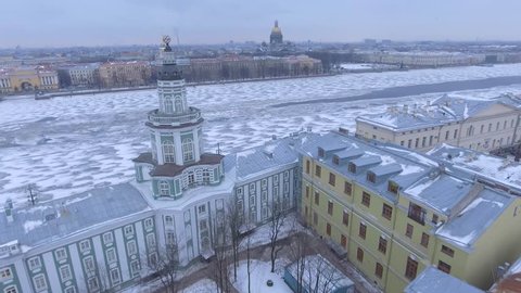 Aerial view Saint Isaac's Cathedral in St.Petersburg Russia. Neva River covered in ice and snow. Winter day, dramatic mood. Unique cinematic 4k drone aerial footage. Accent and drift. City panorama