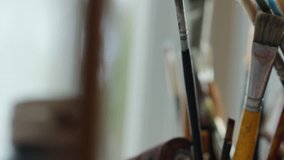 Art studio paint brushes and ink paintings - Powered by Shutterstock - Get 15% off with code: PIKWIZARD15