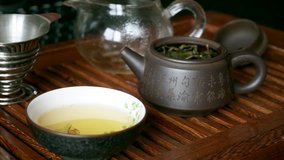 Chinese tea ceremony. Man pours boiling water over tea in a Yixing teapot  on tea table - Powered by Shutterstock - Get 15% off with code: PIKWIZARD15