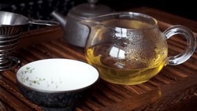Chinese tea ceremony. Man pouring tea from Cha Hai in to cup on tea table - Powered by Shutterstock - Get 15% off with code: PIKWIZARD15