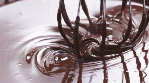 Slow motion of mixing melted premium dark chocolate with a whisk, 180fps prores footage