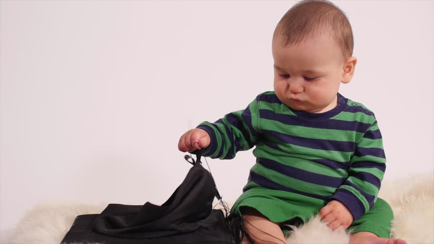 Infant boy not interested in academic hat - skip school Royalty-Free Stock Footage #24122545