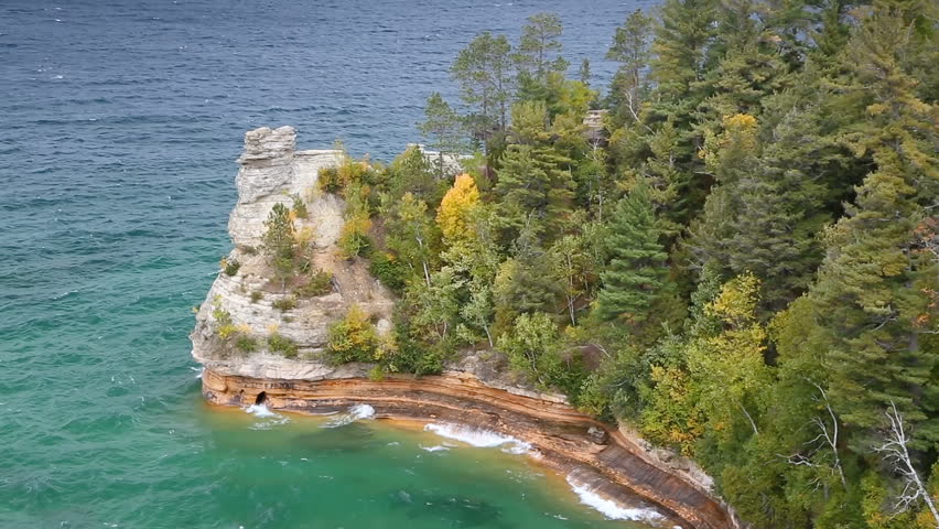 Looping video features Miners Castle, a coastal formation that juts into Lake Superior at Pictured Rocks national Lakeshore near Munising, Michigan, with waves crashing on a windy autumn afternoon.