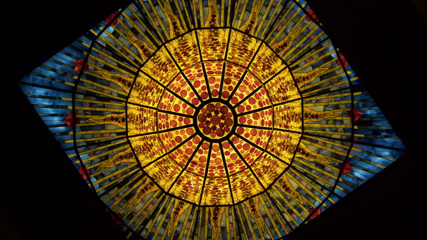 Crystal chandelier and art of glass mosaic. Round chandelier decorated with a mosaic of stained glass. Round design, camera spin, rotating frame. Church, cathedral or museum ceiling
