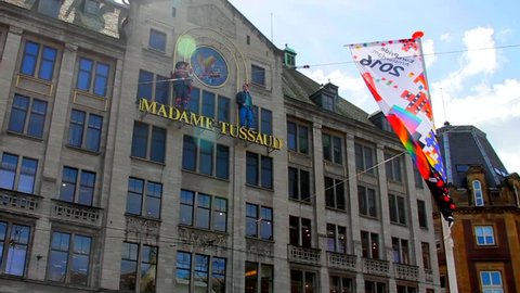 AMSTERDAM, NETHERLANDS - AUGUST 9, 2016: The exterior of Madame Tussaud museum at Dam Square at the city center on summer blue cloudy sky background 