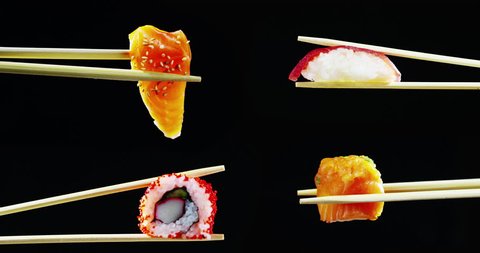 Sushi, sashimi, uramaki and nighiri. typical Japanese dish consisting of rice, salmon, tuna,shrimp and fish eggs on a black background. 