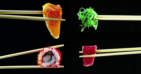 composition of sushi,sashimi,uramaki and nighiri.typical Japanese dish consisting of rice, salmon, tuna,shrimp and fish eggs on a black background.Concept:Japanese restaurant,sushi,oriental tradition