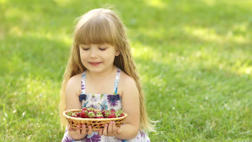 Child with a basket of strawberries

