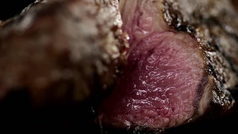 MACRO FOOD: rack of lamb is cut in half slow motion