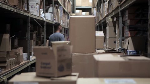 Worker searching for item in a warehouse
