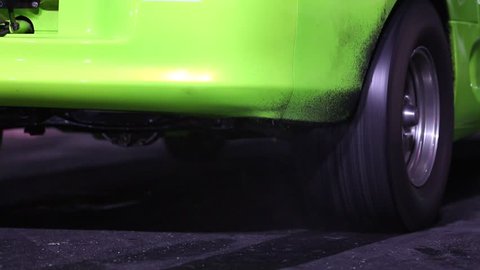 Drag racing car burns rubber off its tires in preparation for the race