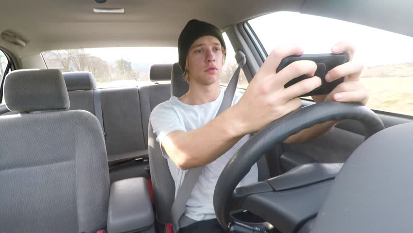 A Teenager Texting And Driving