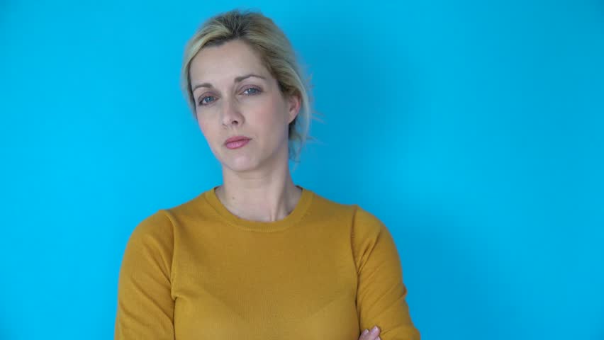 Blond woman on blue background having different expressions