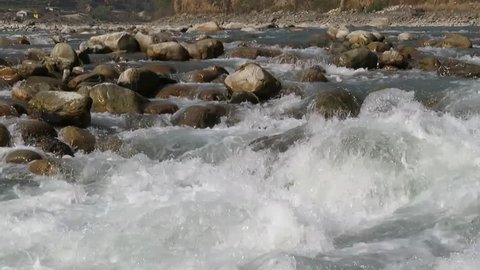 Water flowing over and around rocks.