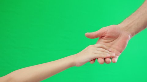 Two holding hands on green screen background. Adult male and teen female hands handshake. Green screen background.
