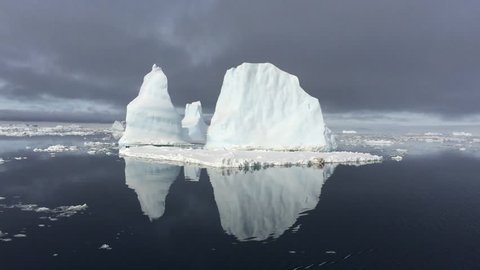 An iceberg in Antarctica reflects in the water. 