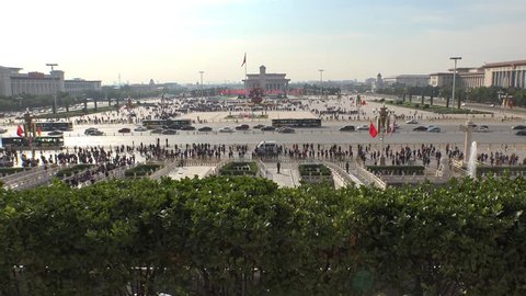 Largest square Tiananmen Square famous public space. Centre of Beijing China. People enter to Forbidden City. Sunny Summer day. Aerial view from above. Road traffic. Assent