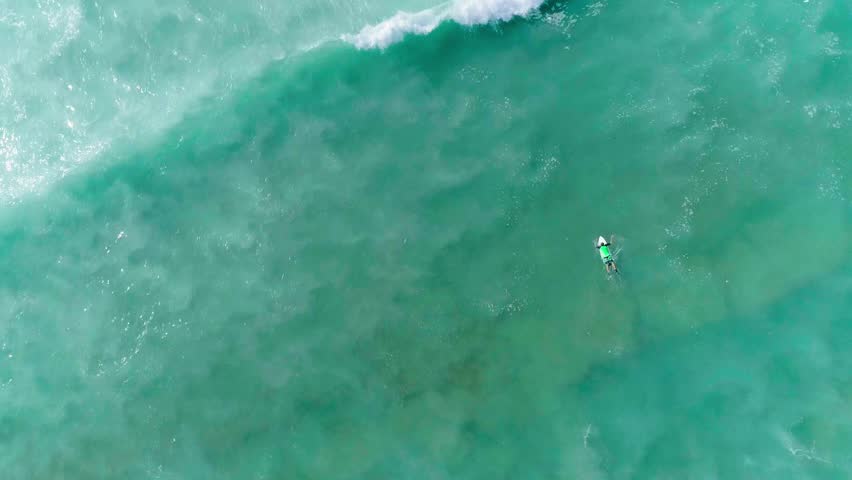Surfer duckdiving through a wave Royalty-Free Stock Footage #24162961