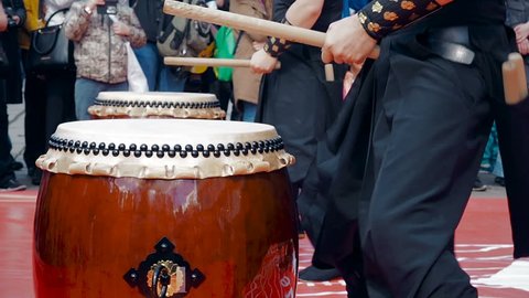 Musicians drummers play taiko drums chu-daiko outdoors. Culture folk music of Asia Korea, Japan, China.